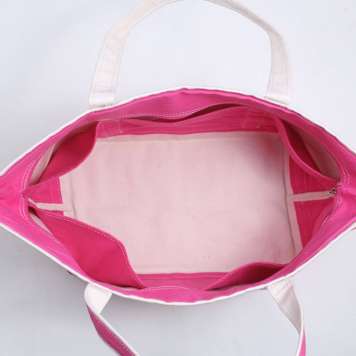 Top view inside the large canvas tote showing the pink lining and interior pockets