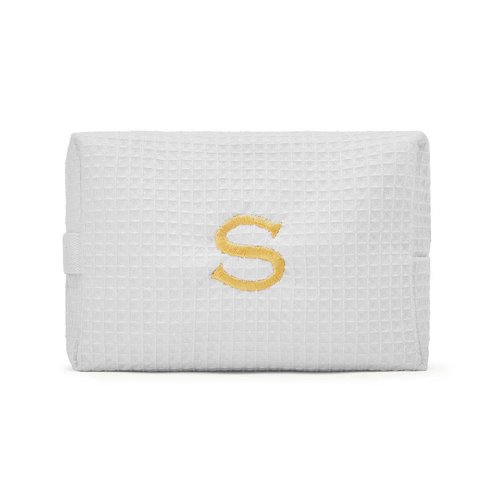 A cotton waffle makeup bag, one of the monogrammed pouches in the collection.