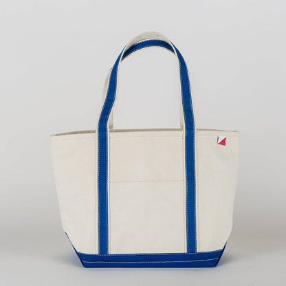 Natural canvas tote bag with royal blue straps, trim and base, shown from the front.