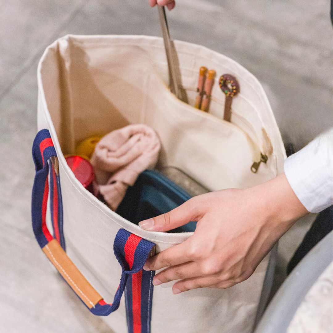 Open tote showing the interior with a slip pocket and items inside