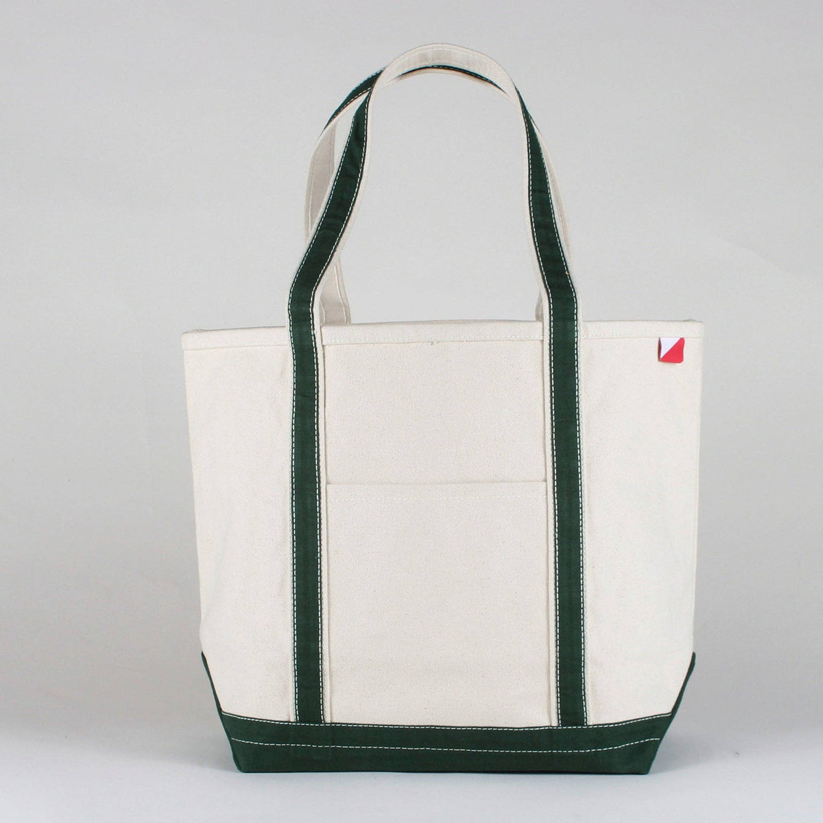 Natural canvas tote with hunter green straps, trim, and base, shown from the front