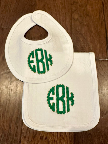 White baby bib and burp cloth monogrammed with a green circle EBK monogram