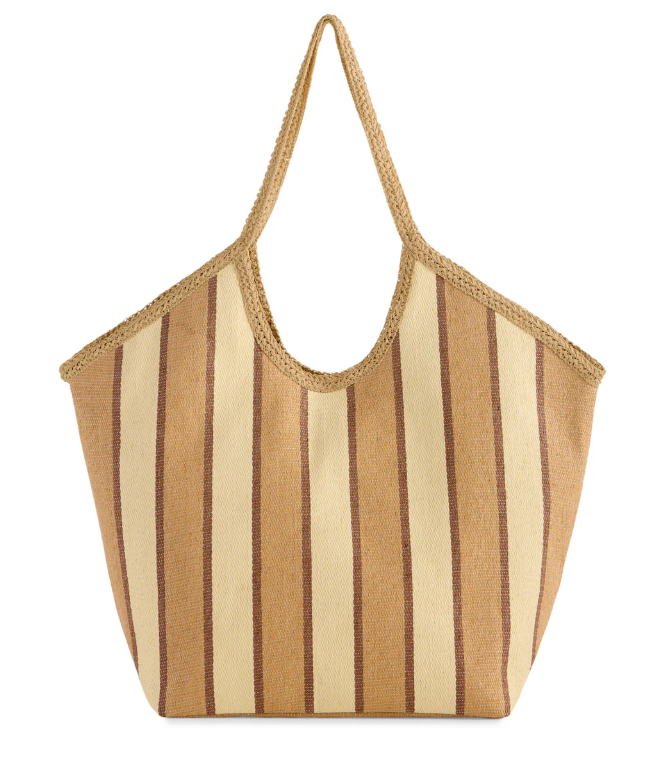 Woven straw tote in tan, cream, and brown stripes with a curved shoulder handle and braided trim