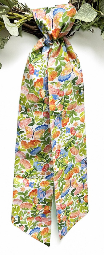 Patterned wreath sash in a watercolor floral print with orange, pink, and blue flowers