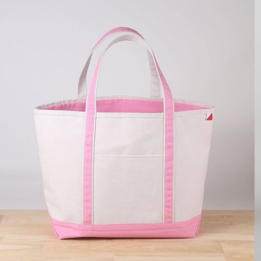 Large natural canvas tote with light pink handles, pink trim, and a pink bottom