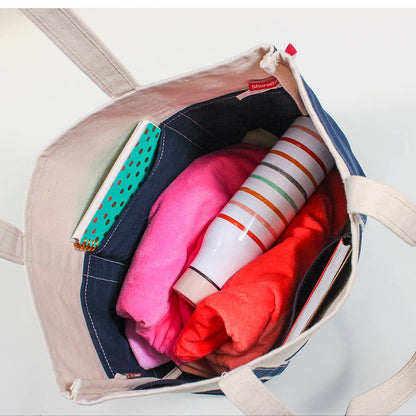 Overhead view inside the open canvas tote showing the blue lining and interior pockets