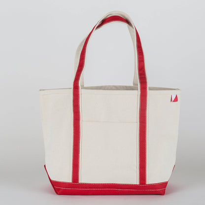 Natural canvas tote with red straps, trim, and base, shown from the front