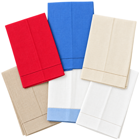 Six folded linen tea towels with hemstitched borders in red, blue, cream, beige, white, and white with a blue border